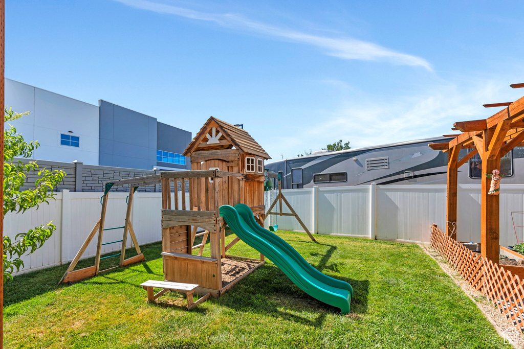 View of playground with a fenced backyard