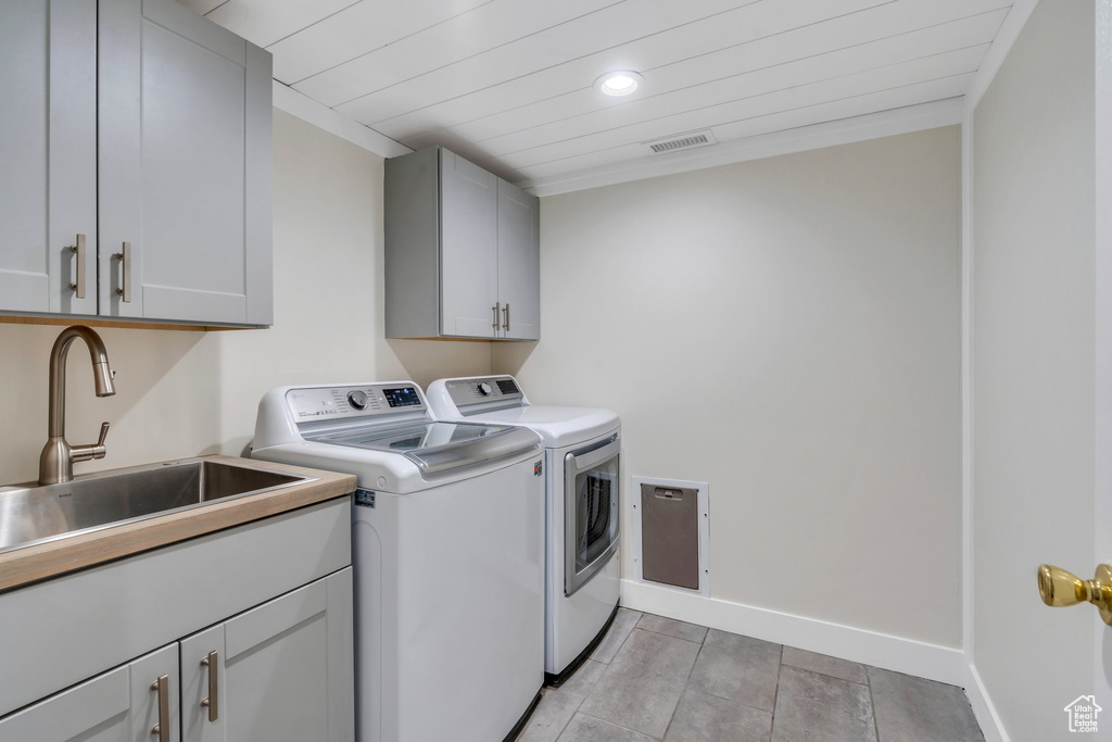 Washroom with washer and dryer, cabinet space, recessed lighting, light tile patterned floors, and wood ceiling