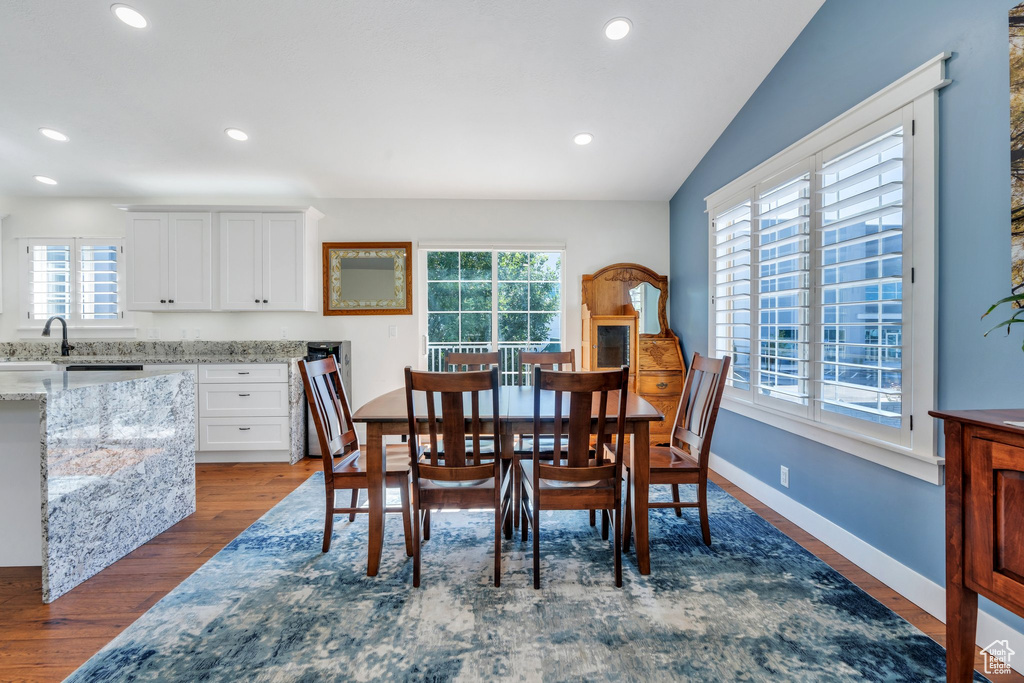 Dining space with dark wood-style flooring and recessed lighting