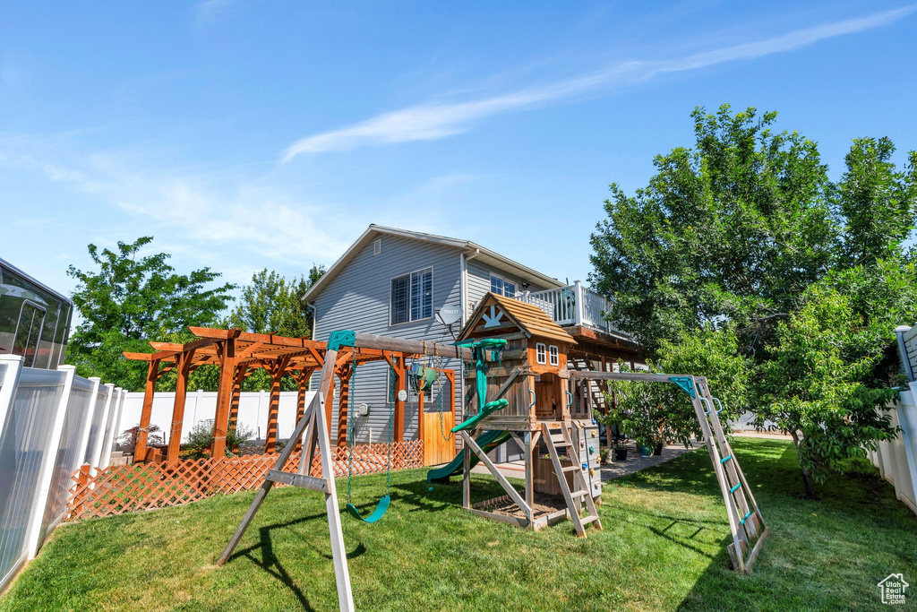 View of jungle gym featuring a pergola and a fenced backyard