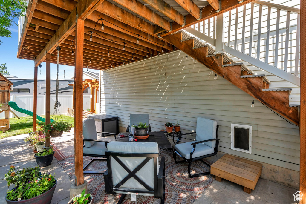 View of patio / terrace with a playground, stairway, and an outdoor living space
