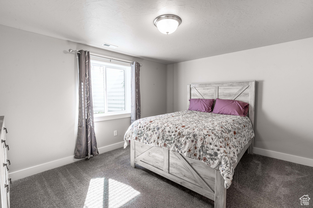 Bedroom with carpet flooring and baseboards