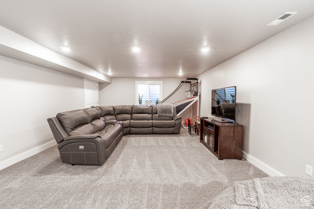 Carpeted living area featuring recessed lighting