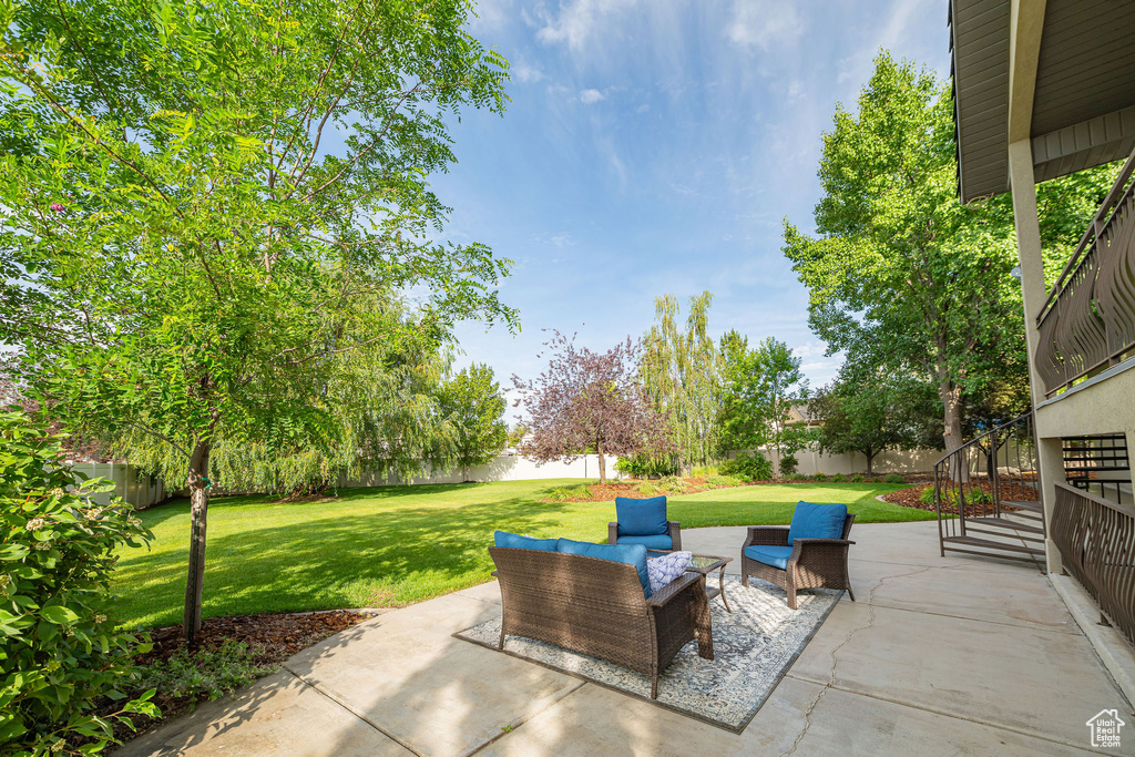 Fenced backyard featuring a patio and an outdoor living space