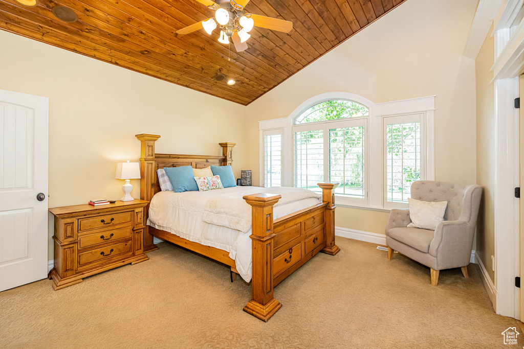 Bedroom with light carpet, wood ceiling, high vaulted ceiling, and ceiling fan