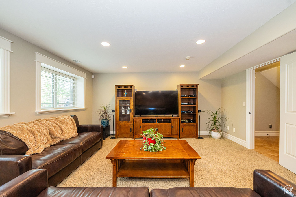 Living area with carpet floors and recessed lighting