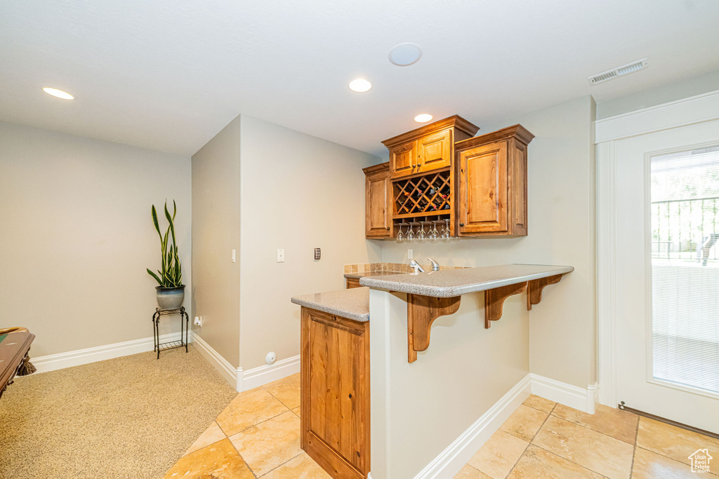 Indoor wet bar featuring recessed lighting and light tile patterned flooring