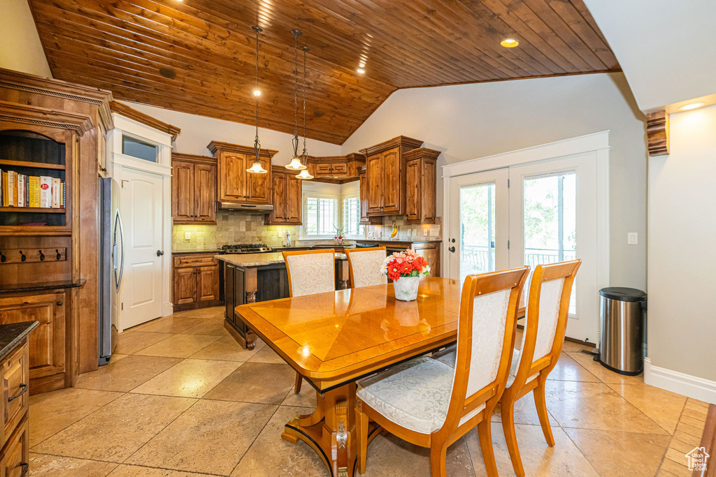 Dining area featuring wooden ceiling, vaulted ceiling, light tile patterned floors, and recessed lighting