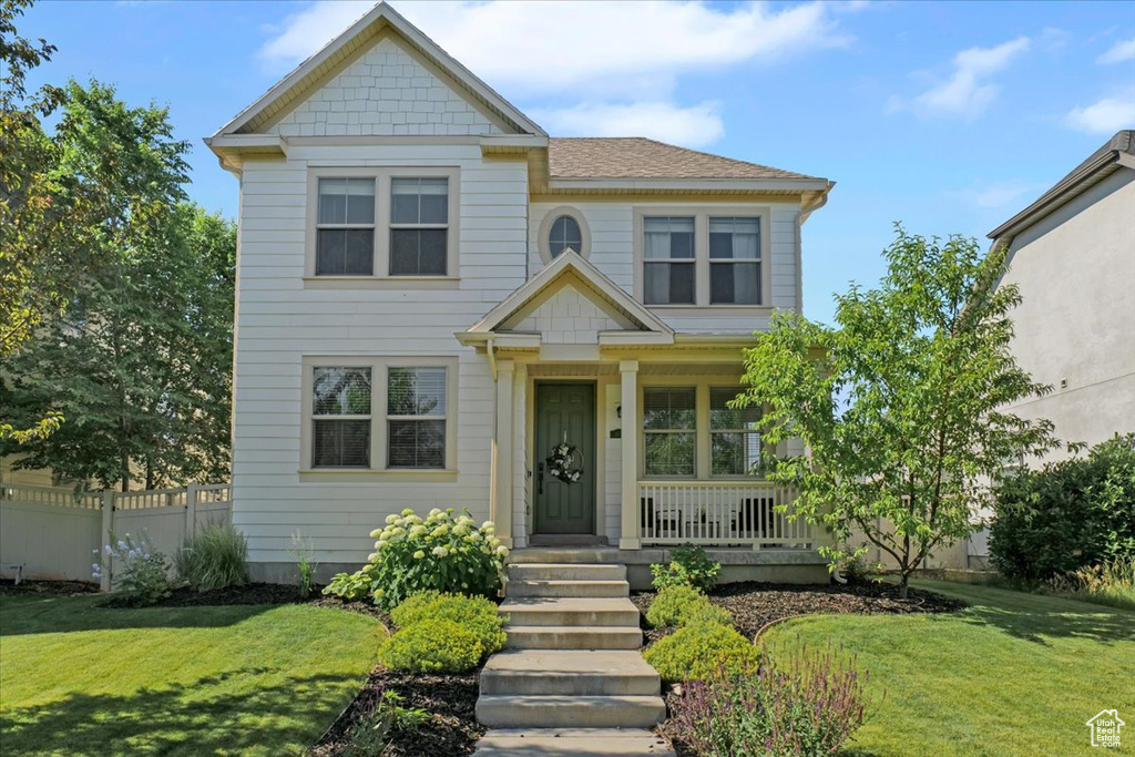 View of front facade featuring a porch and a shingled roof