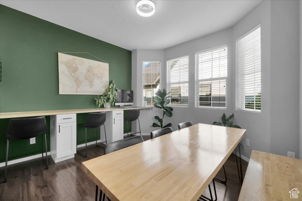 Home office with dark wood finished floors and baseboards