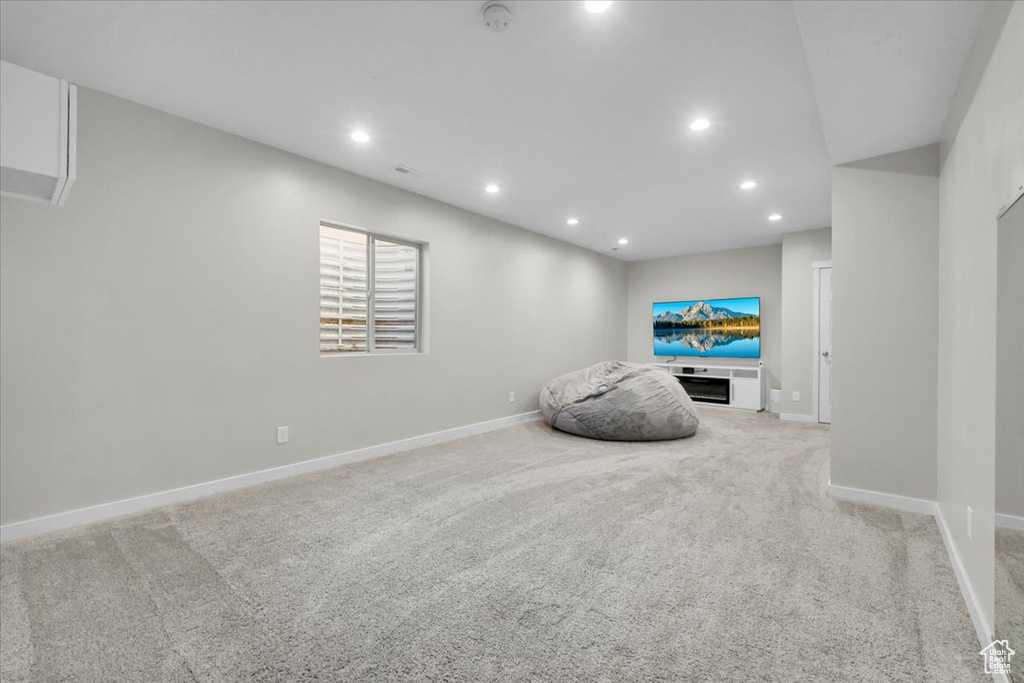 Unfurnished room with recessed lighting and light carpet