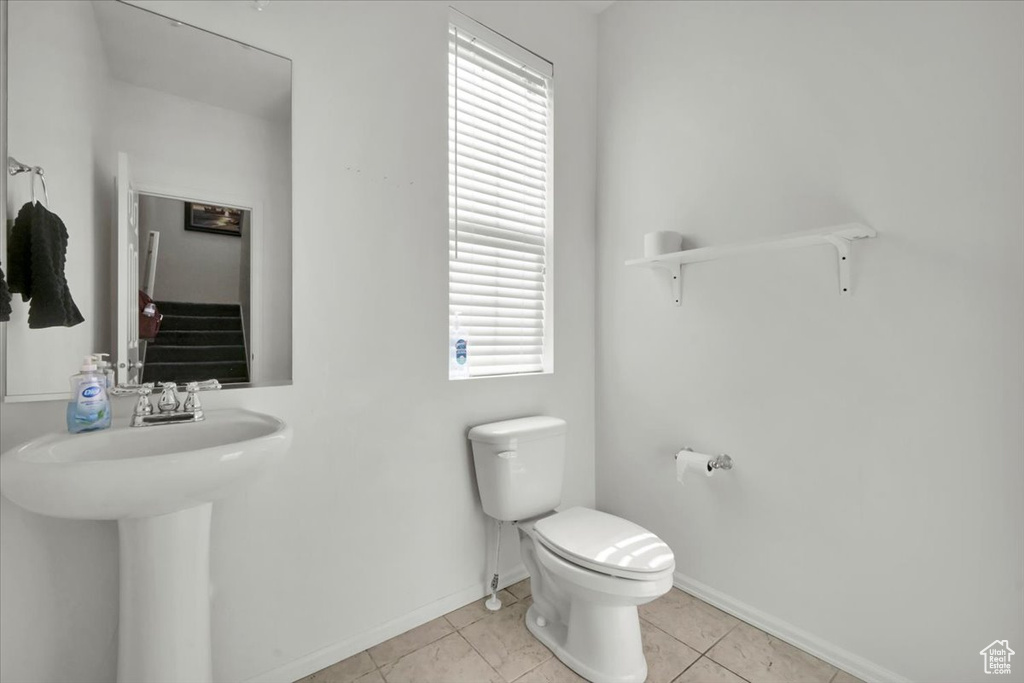 Bathroom featuring toilet and tile patterned flooring