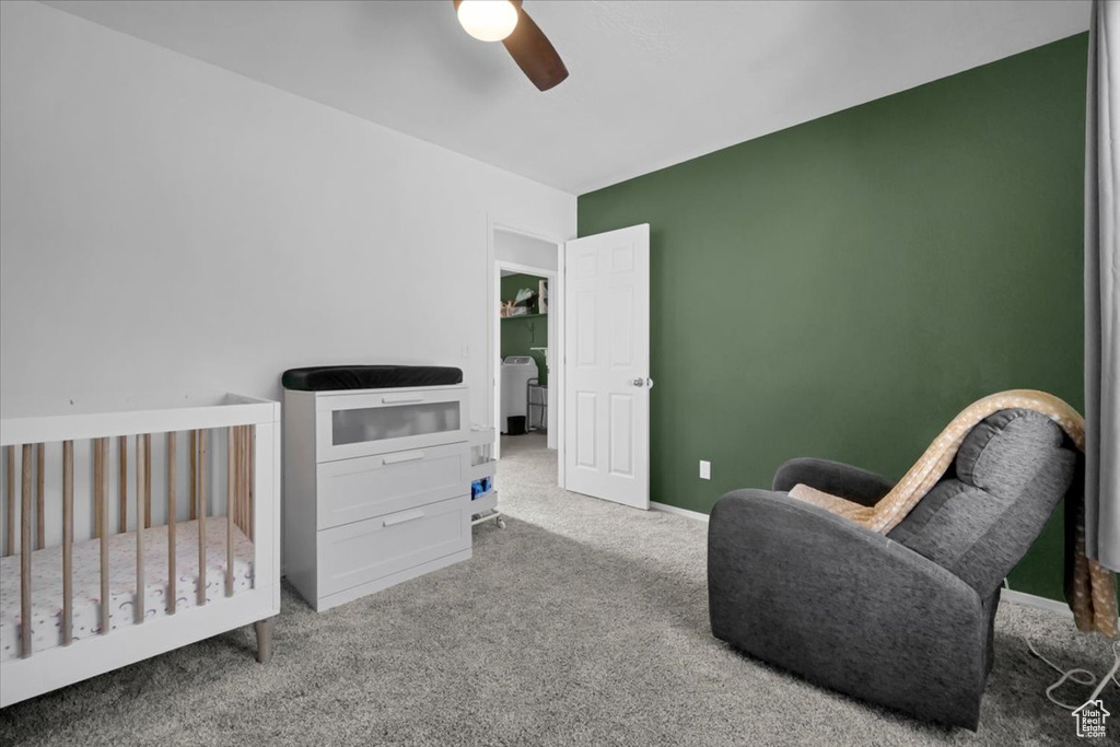 Carpeted bedroom with a ceiling fan