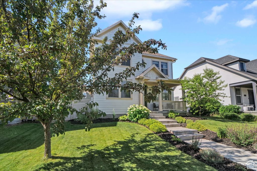 View of front of home featuring a porch and a front yard