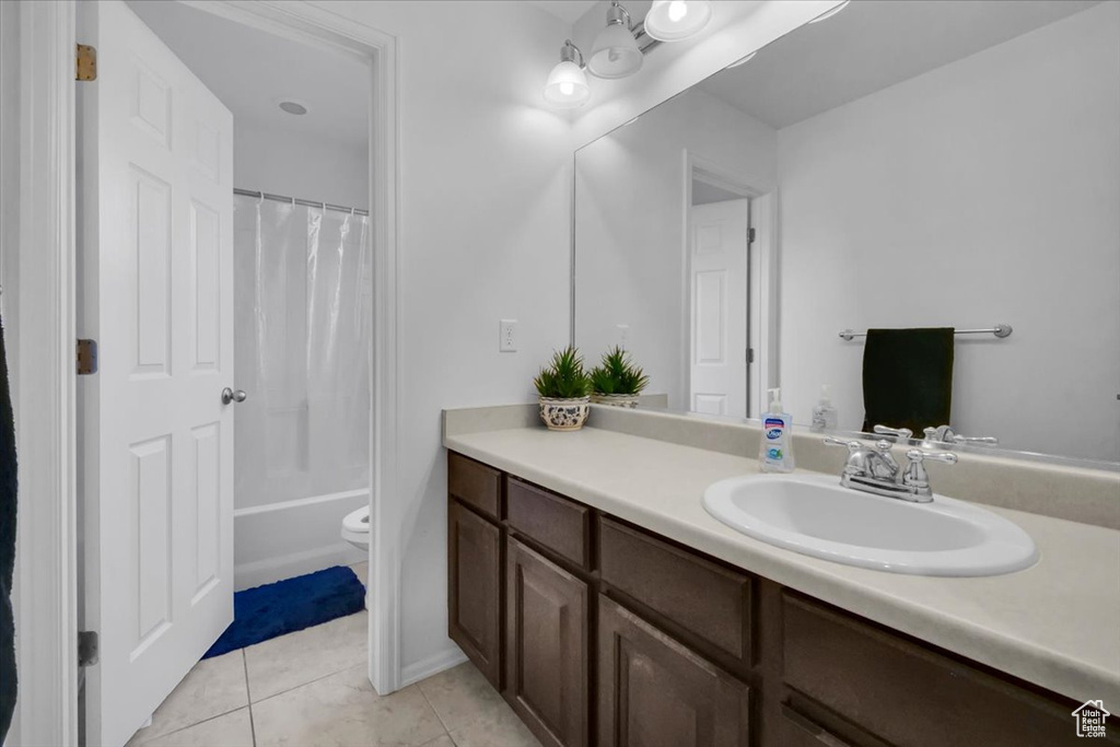 Full bathroom featuring vanity, tile patterned floors, and shower / tub combo with curtain