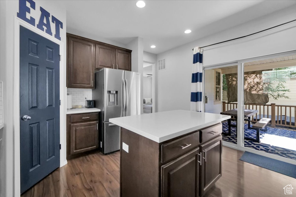 Kitchen featuring stainless steel fridge with ice dispenser, dark wood finished floors, dark brown cabinetry, and recessed lighting