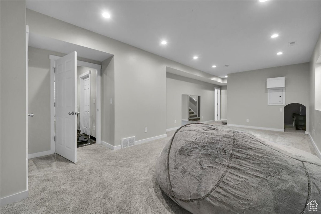 Basement with recessed lighting, carpet flooring, and stairs