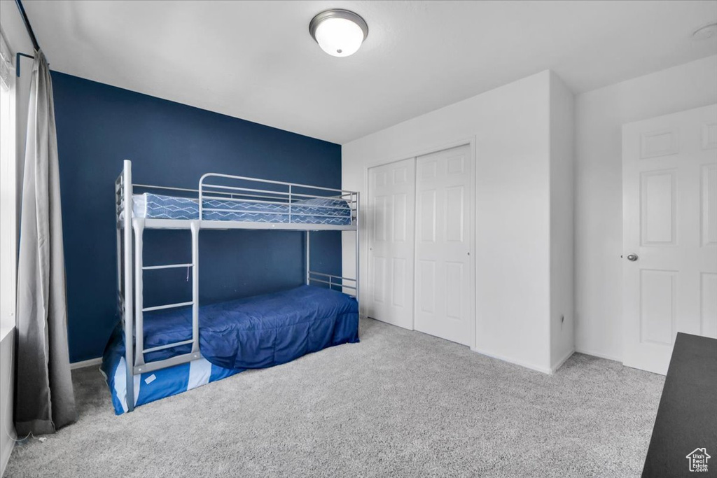 Bedroom featuring carpet floors and a closet