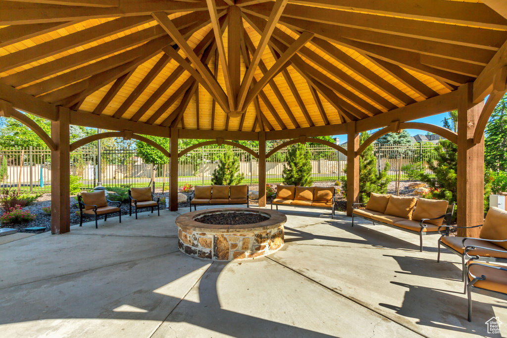 View of patio featuring an outdoor living space with a fire pit and a gazebo