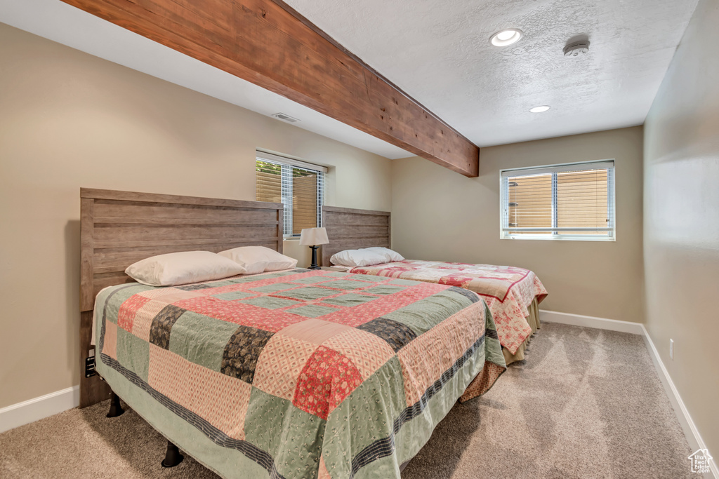 Bedroom with carpet floors, a textured ceiling, and recessed lighting