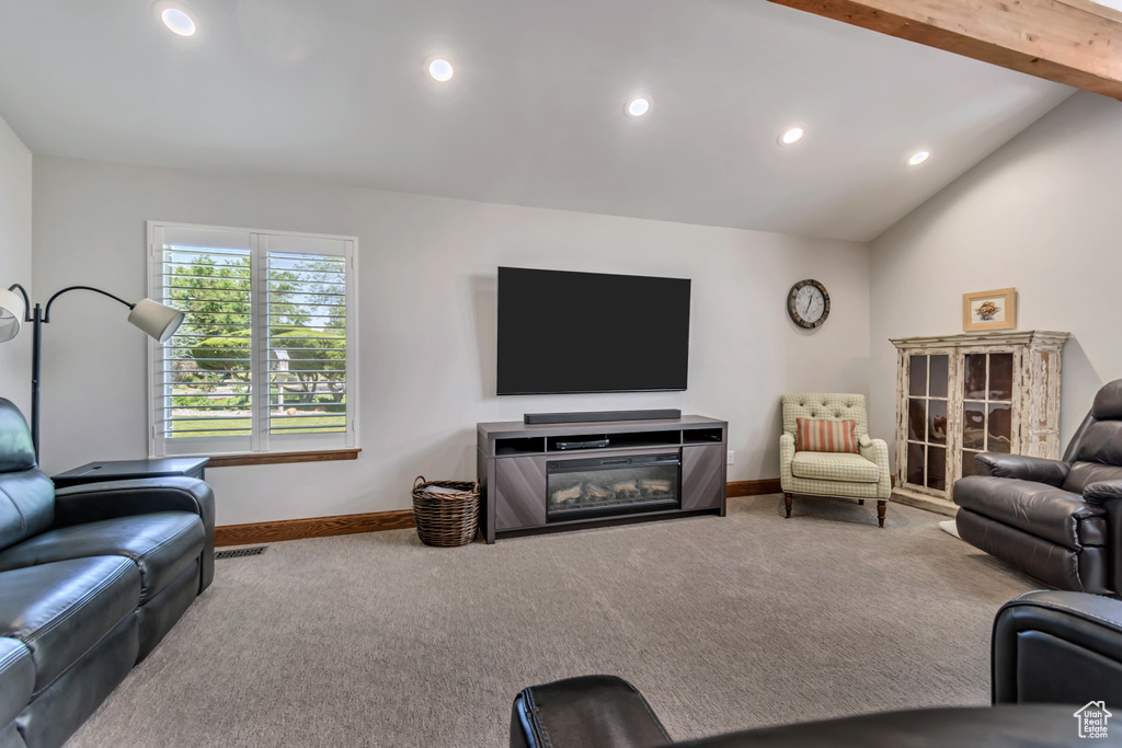 Living room featuring carpet, recessed lighting, and lofted ceiling