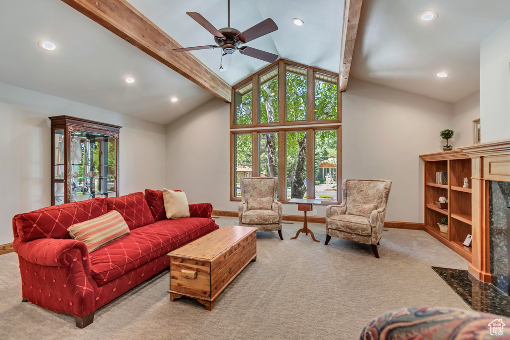 Carpeted living area featuring a ceiling fan and recessed lighting