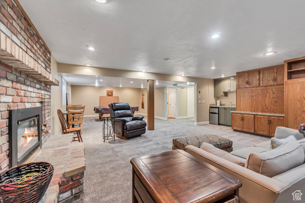 Living room with light colored carpet, a fireplace, and recessed lighting