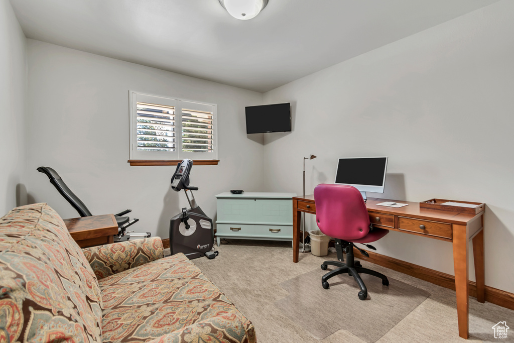 Carpeted office space with baseboards