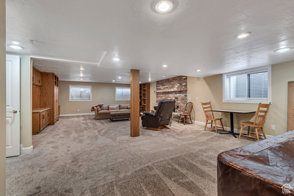 Living area featuring light colored carpet, a dry bar, and recessed lighting