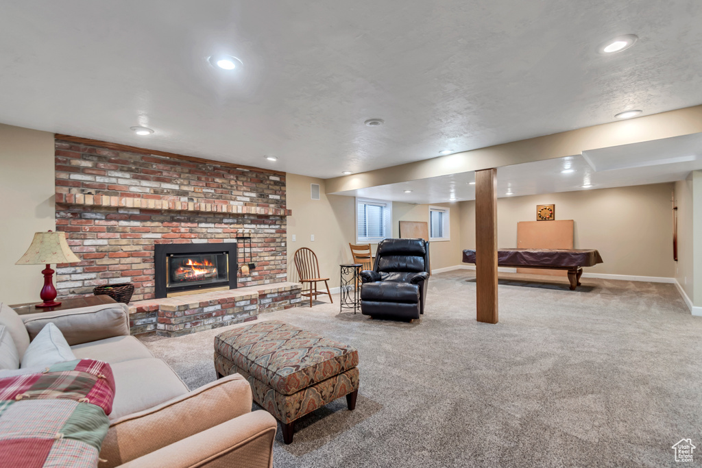Living room with carpet floors, recessed lighting, a fireplace, and billiards table