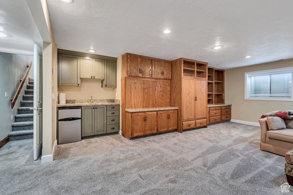 Living area featuring light colored carpet, stairway, and recessed lighting