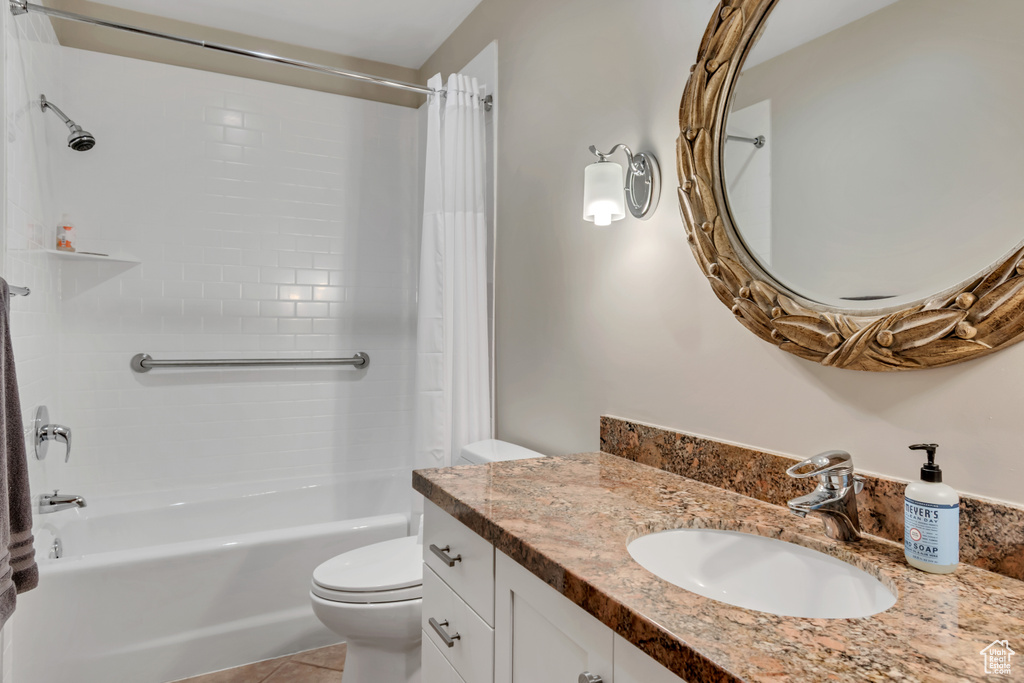 Bathroom with shower / bath combination with curtain, vanity, and tile patterned flooring