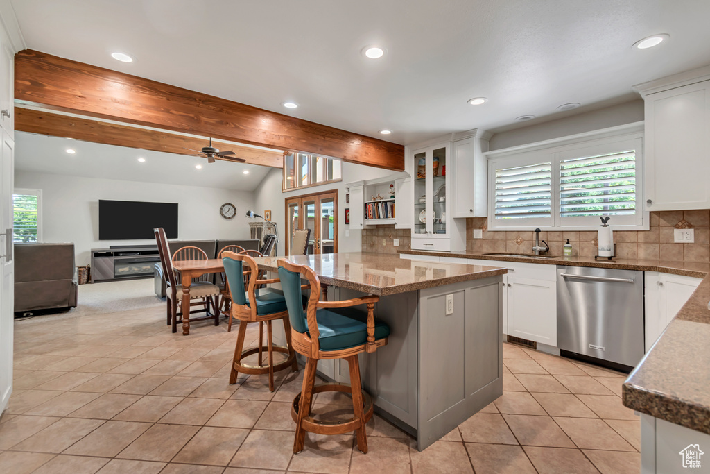 Kitchen with dishwasher, light tile patterned floors, tasteful backsplash, white cabinetry, and recessed lighting