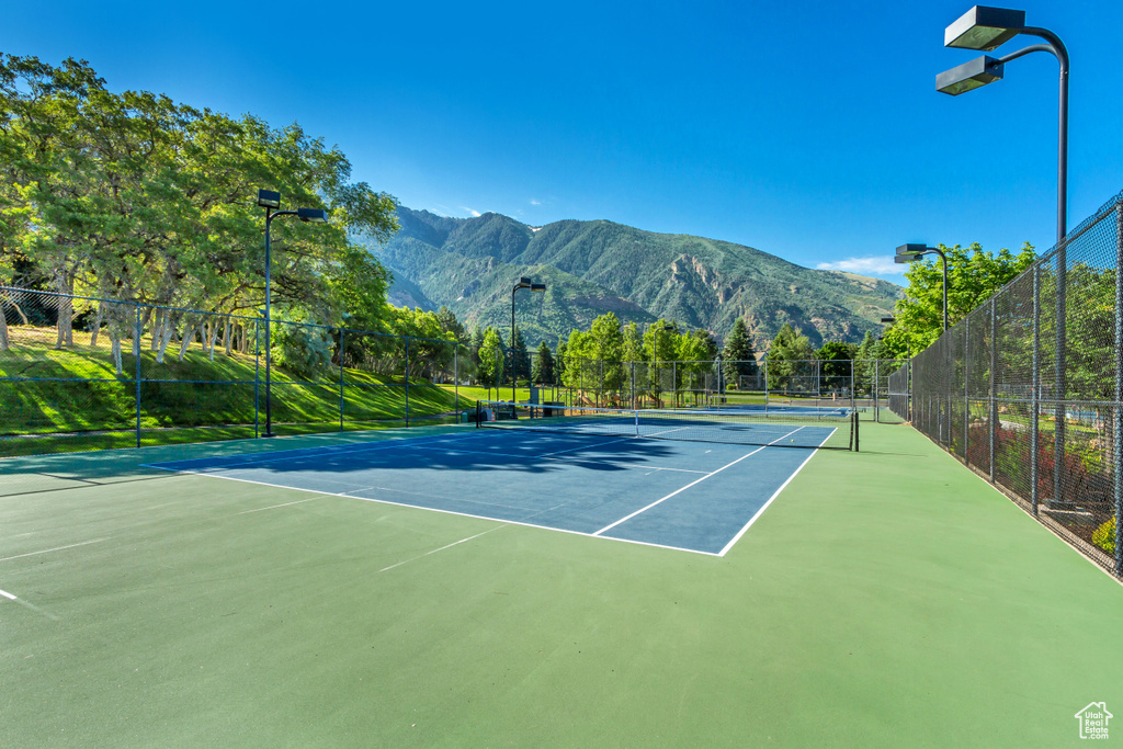 View of tennis court with a mountain view