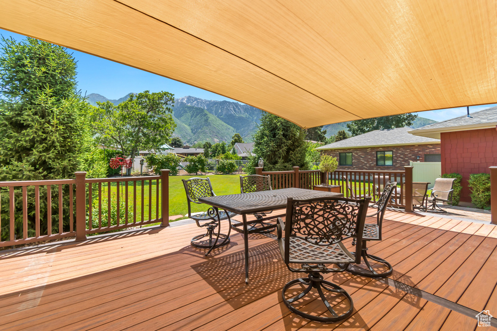 Wooden terrace with outdoor dining space and a mountain view