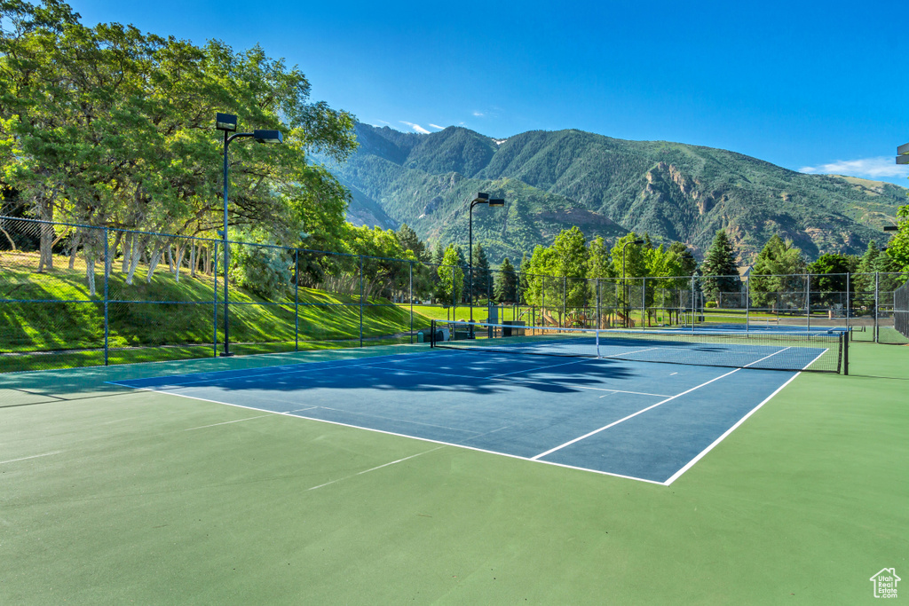 View of tennis court with a mountain view