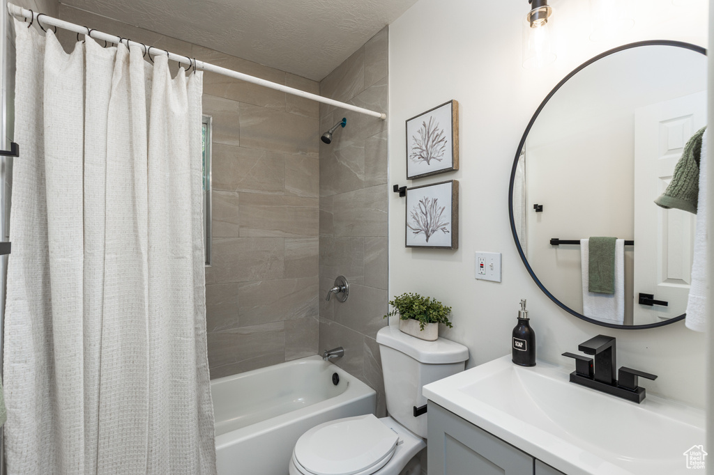 Bathroom featuring vanity and shower / bath combo with shower curtain