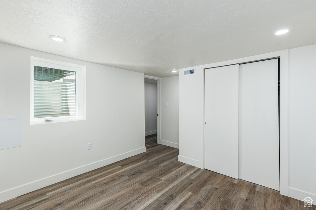 Unfurnished bedroom with wood finished floors, a closet, and recessed lighting