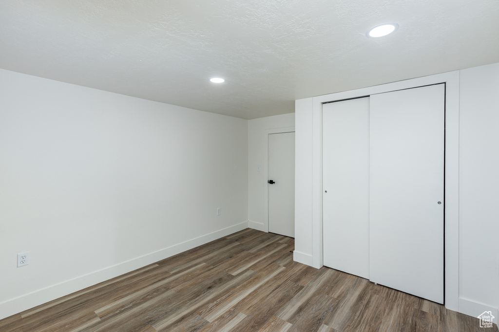 Unfurnished bedroom with wood finished floors, a closet, and recessed lighting