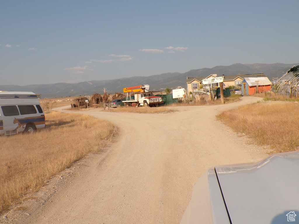 View of dirt / gravel road with a mountain view