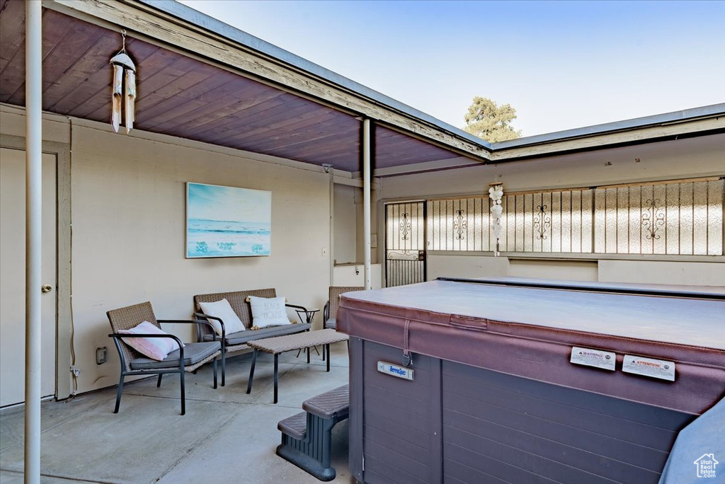 View of patio featuring a hot tub