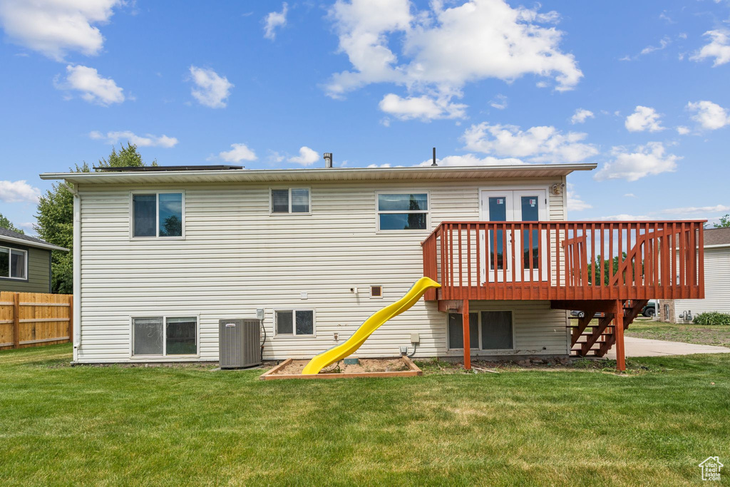 Rear view of house with stairs and a wooden deck
