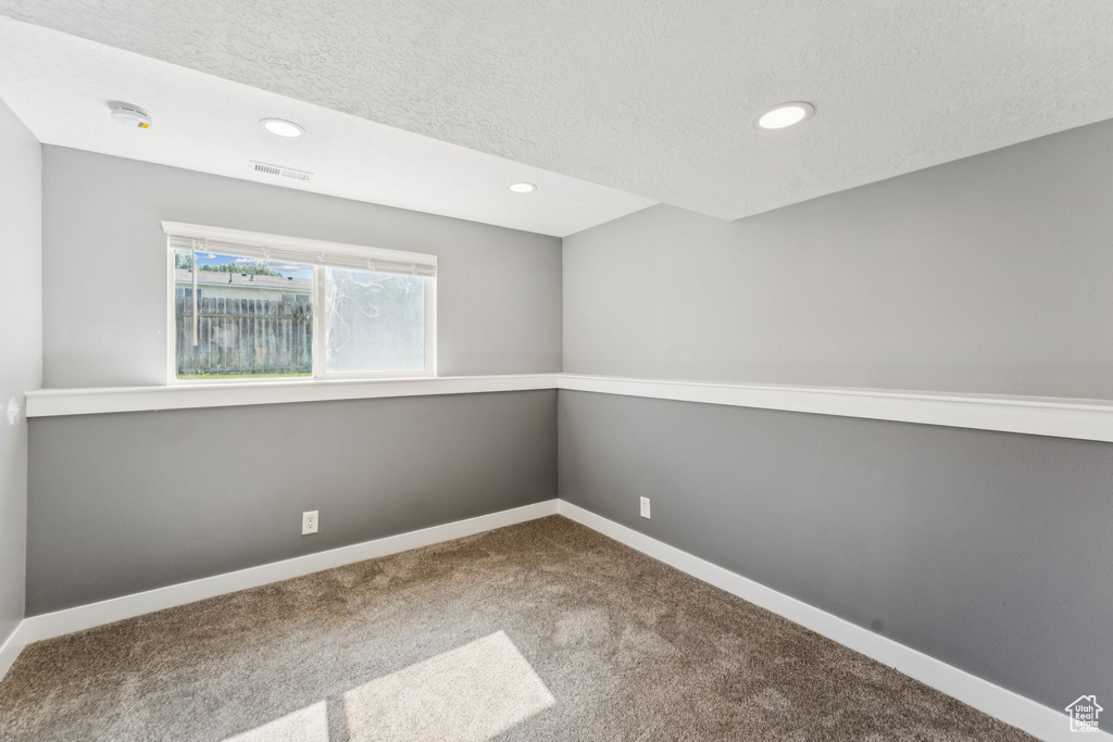 Spare room with carpet, a textured ceiling, recessed lighting, and a smoke detector