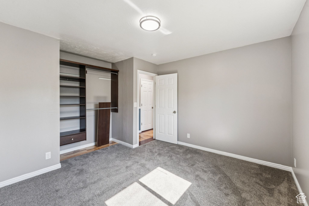 Unfurnished bedroom featuring carpet and a closet