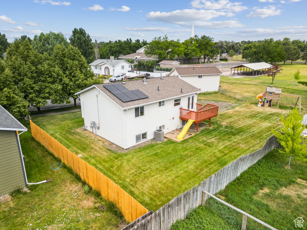 Aerial view of property and surrounding area with a tree filled landscape