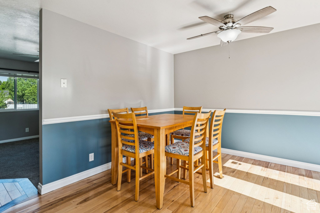 Dining area featuring ceiling fan and wood finished floors