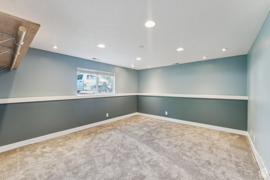 Carpeted spare room with recessed lighting and baseboards