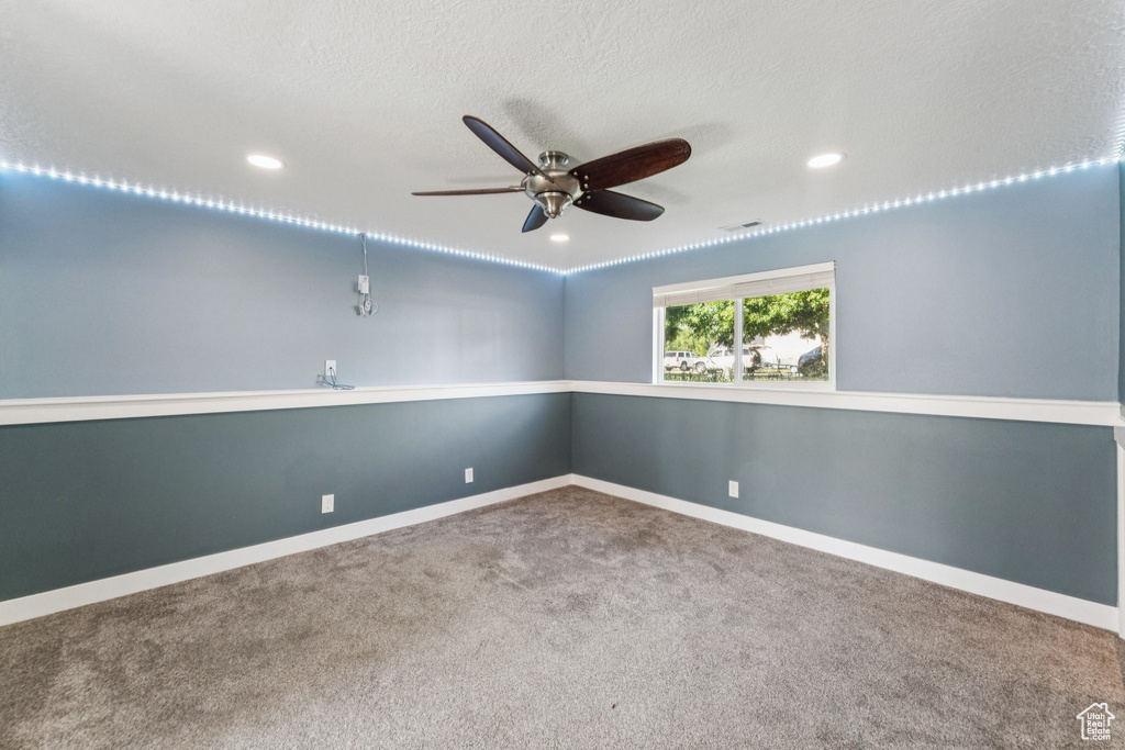 Empty room with a ceiling fan, carpet floors, and recessed lighting