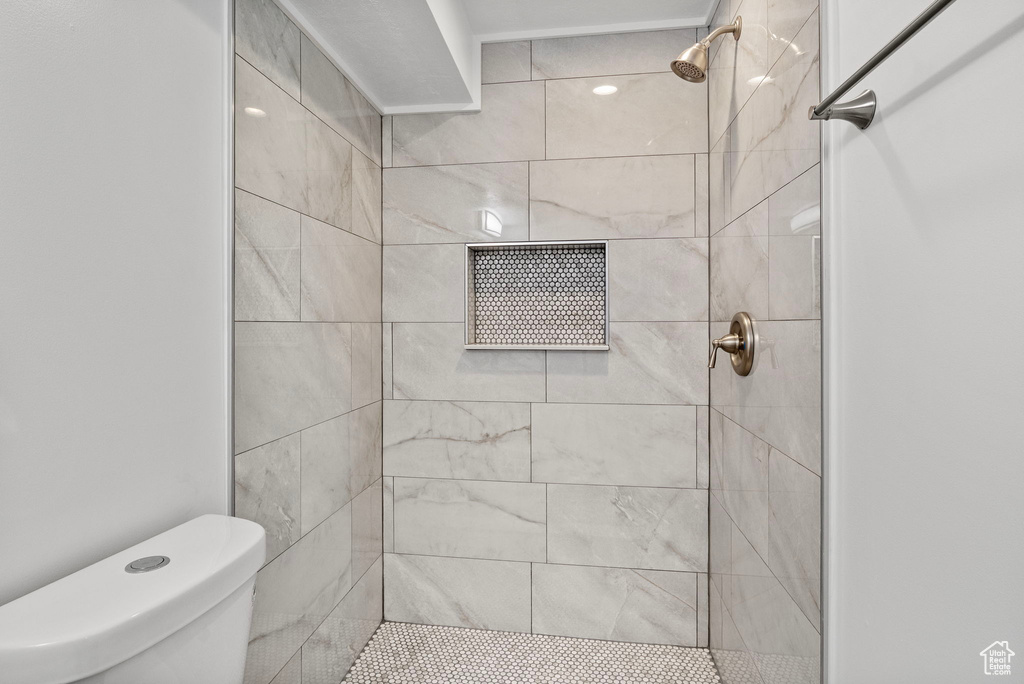 Bathroom with a tile shower and toilet