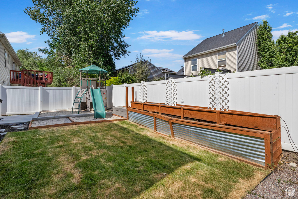 Fenced backyard with a playground